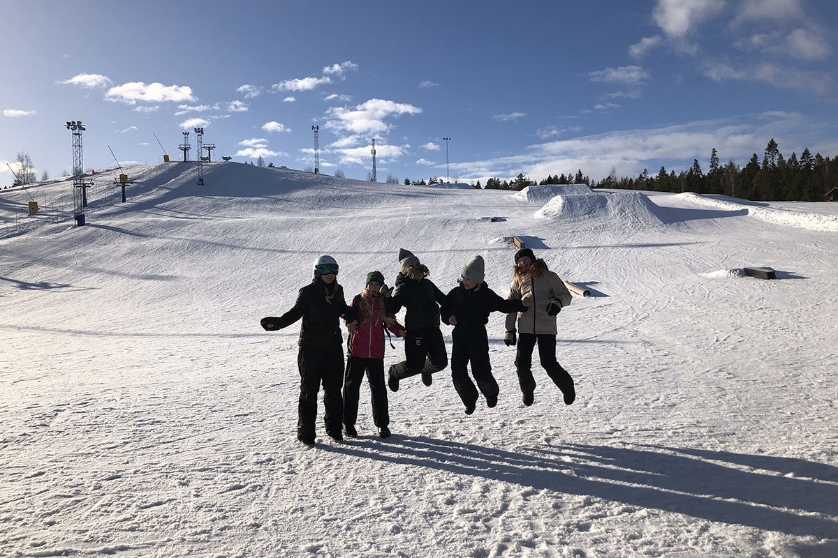 Vänner framför det snötäckta berget.
